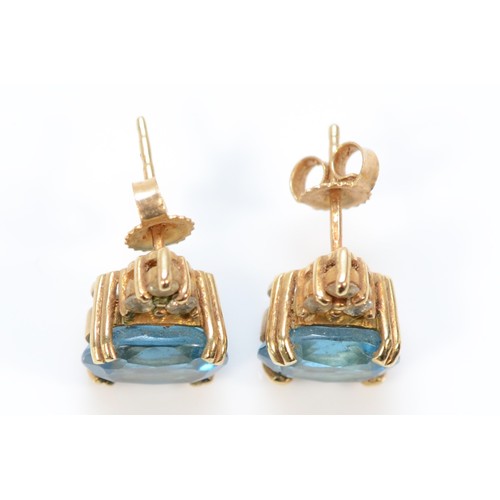 611 - A pair of 9ct gold blue topaz and diamond earrings with scroll backs, 10mm, 2.9g