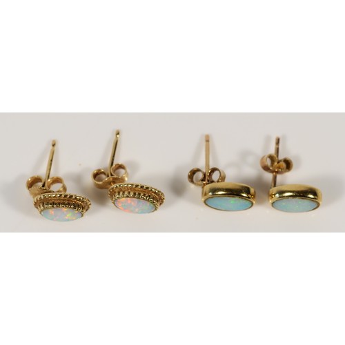 620 - A pair of 9ct gold opal earrings with scroll backs, together with a similar synthetic opal pair, 3g