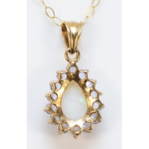 632 - A 9ct gold opal and tanzanite pendant with chain, 12mm pendant, 1.5g