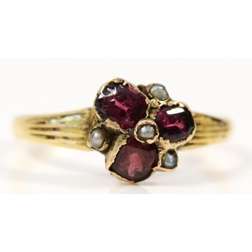 634 - A 9ct gold vintage garnet and seed pearl dress ring, M, 1.7g, 8mm across