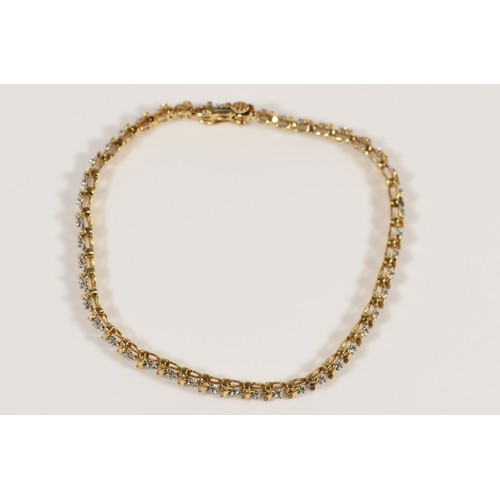 665 - A 9ct gold diamond line bracelet, 18cm, 6.9g