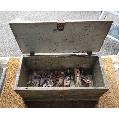 22 - A wooden toolbox containing a collection of hand planes.