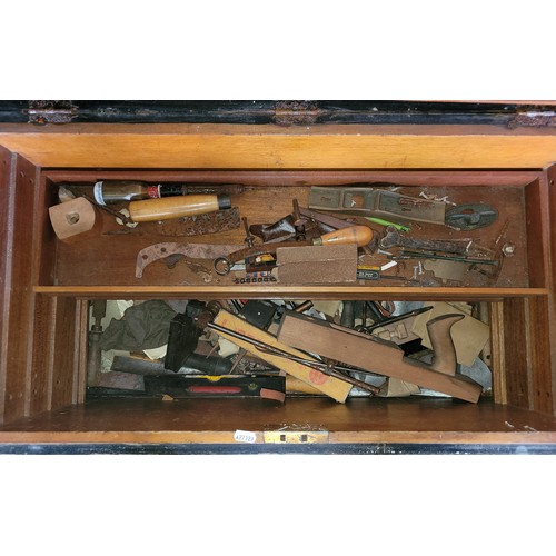 35 - A large toolbox containing a collection of carpenters hand tools.