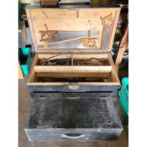 36 - A large toolbox containing a collection of carpenters hand tools.