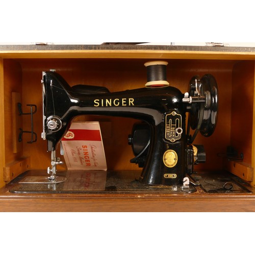 111 - An early 20th century manual Singer sewing machine, model 99K, with instruction manual and fitted tr... 