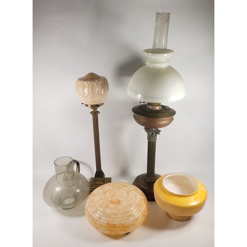 120 - A collection of lamps and lampshades, to include, an oil lamp with brass stem and mid-century style ... 