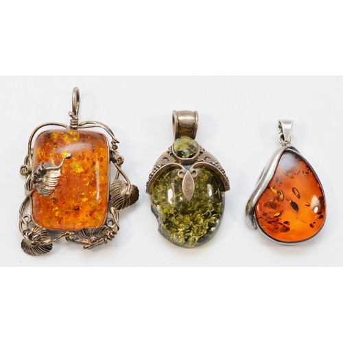 1145 - A large silver and amber floral pendant, stone 45 x 30mm and two other silver mounted amber pendants... 