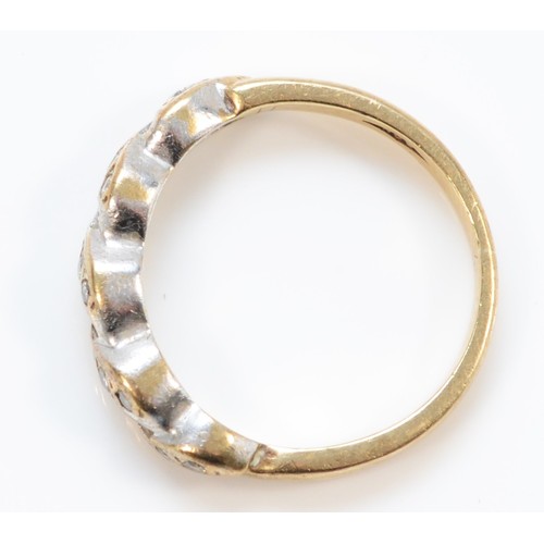 1216 - A 9ct gold brilliant cut diamond twist ring, L, 2.6gm