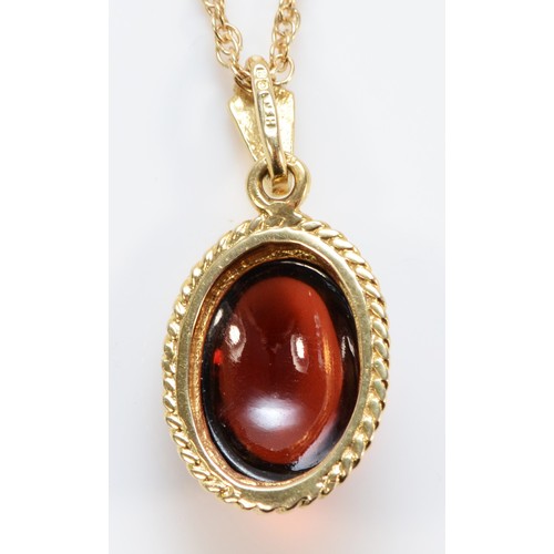 1220 - A 9ct gold and cabochon garnet pendant, stone, 13 x 10mm, 38cm chain, 4.5gm