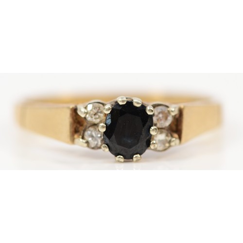 1475 - A 9ct gold diamond and sapphire ring, 4mm sapphire flanked each side by two diamonds, L, 1.8g