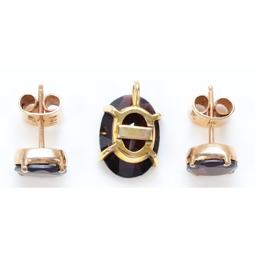 1381 - A pair of 9ct gold garnet earrings together with a matching pendant, 14mm x 10mm pendant, 5.1g