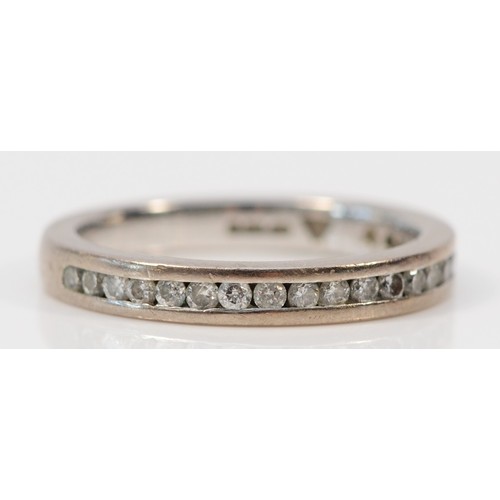 1390 - An 18ct white gold channel set diamond half eternity ring, K, 3.4g