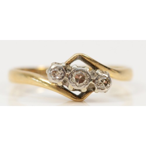 1399 - An 18ct gold and platinum vintage diamond trilogy cross over dress ring, K, 2g