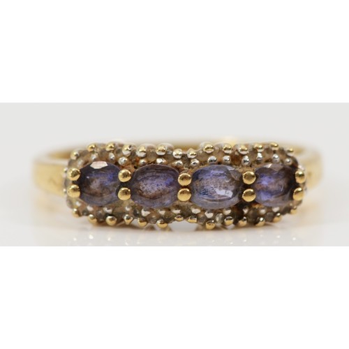 1440 - A 9ct gold tanzanite four stone ring with diamond frame, P, 2.2g