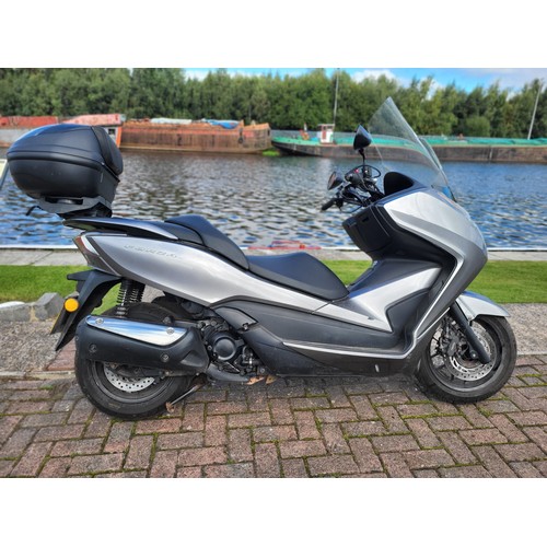 2013 Honda Forza NSS300 Scooter, 279cc. 14,338 Miles. Registration Number LN63 XEJ. Vin Number MLHNF04B7D5002270, Engine Number NF04E2004165.
Sold with V5c, Current MOT, Owners Pack, Datatag pack, old MOTs.
In 1954 Honda, shortly after the company was established, launched the 220cc Juno K scooter. 1962 saw the advent of the 125cc Juno M80; both machines shared a Badalini-type hydraulic-mechanical transmission and Honda's desire to build in comfort, convenience and fun.
The early 1980s saw huge growth in the popularity of small capacity scooters in Japan. In 1984 Honda debuted the 250cc single-cylinder Freeway, a scooter designed for rider and passenger to enjoy ‘further and faster', and 1986 saw the Fusion join the market. The 250cc, single-cylinder Foresight launched in 1996 was labeled as a ‘Sports Scooter', and blended agile performance with a comfortable ride. A 125cc version was sold in Europe as the Pantheon.
Honda went on to help establish the market for larger capacity scooters by developing the 250cc-300cc class in the late ‘90s. The original Forzascooter, unveiled in 2000, delivered a sporty ride, combined brakes and plenty of storage room. It was well received in Europe, where owners found its multi-role capability great for getting to work or college, and also for leisure. A continuous development program resulted in the 2013 NSS300, launched in 2013.
XEJ has been recently MOT tested, starts instantly, is running really well. It provided a very comfortable ride on test around our car park. The vendor is only selling due to lack of use. It is described as being in good condition, and comes with Oxford heated grips, a Givi top box and Datatag security. With excellent luggage capacity a nippy engine, CVT transmission and good handling, the Forza would make the perfect commuter bike, or a great comfortable tourer for a rider with compromised agility.