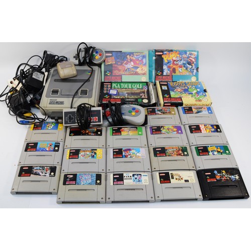 A Super Nintendo console, with controllers, cables and several games to ...