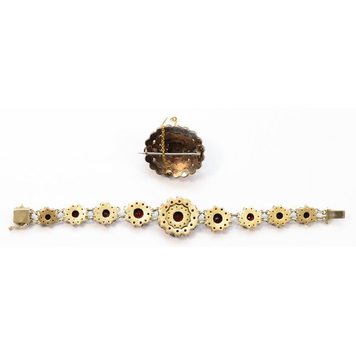 11 - A low grade silver gilt Bohemian garnet cluster bracelet, lacking one link, 15cm and an oval brooch,... 