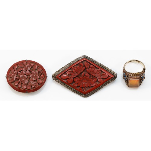 47 - A Chinese silver enamel and hardstone ring,  and two silver mounted cinnabar lacquer brooches, 19gm