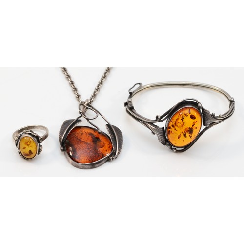 60 - A 925 silver and amber hinged bangle, 55 x 45mm, a silver and amber ring, and a silver and amber pen... 