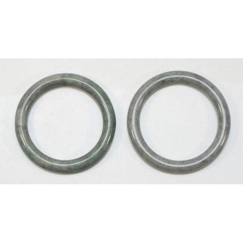 62 - Two jadeite bangles, 61 and 65mm internal diameter