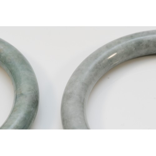 62 - Two jadeite bangles, 61 and 65mm internal diameter