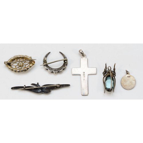 68 - A 935 standard silver and paste crescent brooch, three other brooches and two pendants, 16gm