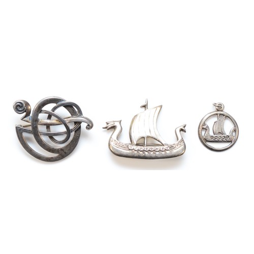 80 - Ola Gorie, a silver entwined brooch and two silver Viking longboats, all signed, 16gm