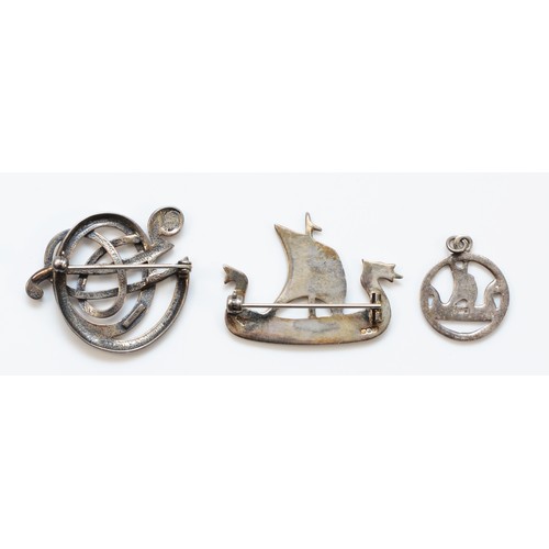 80 - Ola Gorie, a silver entwined brooch and two silver Viking longboats, all signed, 16gm