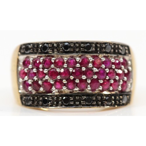 114 - A 9ct gold pave set ruby and black gemstone dress ring, P, 5.1g