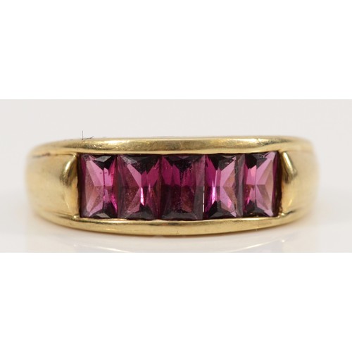 127 - A 9ct gold purple gemstone dress ring, channel set, O, 3.9g