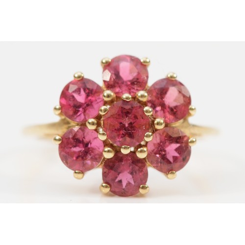 134 - A 9ct gold fushia pink gemstone floral cluster ring, N, 15mm ring front, 2.5g