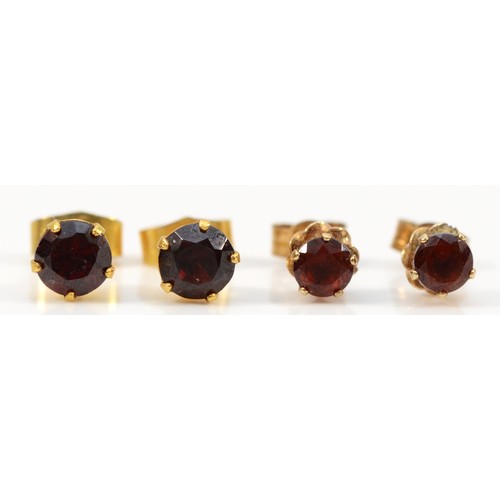 145 - Two pairs of 9ct gold vintage garnet stud earrings with scroll backs, 1.4g