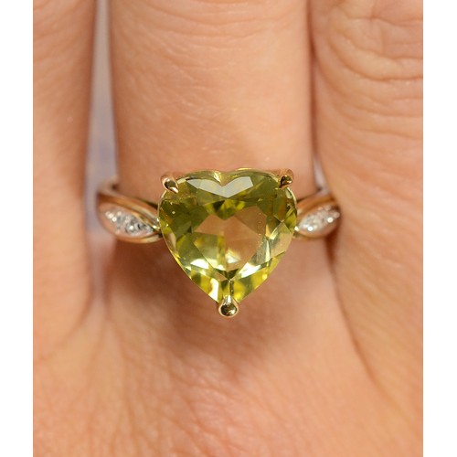 162 - A 9ct gold heart cut citrine dress ring with diamond set shoulders, N, 3.3g