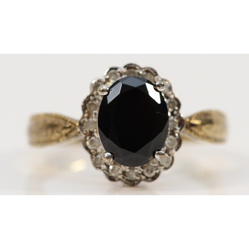 176 - A 9ct gold vintage diamond and hematite halo dress ring, P, 3.3g