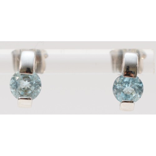 181 - A pair of 9ct white gold blue topaz earrings with scroll backs, 6mm topaz, 2.6g