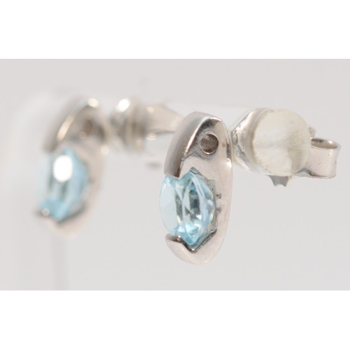 181 - A pair of 9ct white gold blue topaz earrings with scroll backs, 6mm topaz, 2.6g