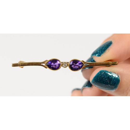 187 - A 9ct gold pear cut amethyst and diamond bar brooch, 50mm across, 2.4g