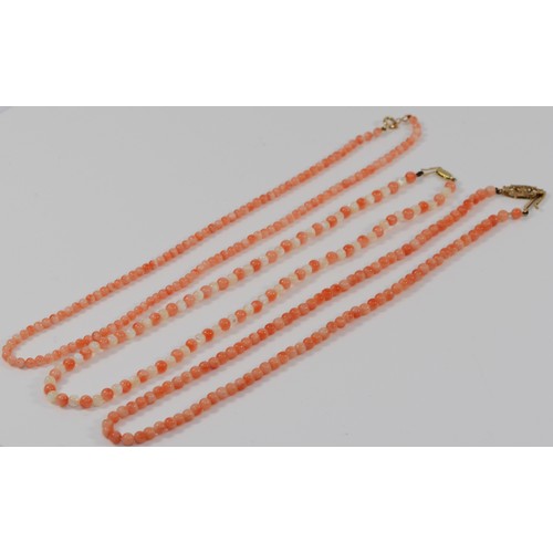 242 - Three coral necklaces, with 9ct gold clasps, 31g