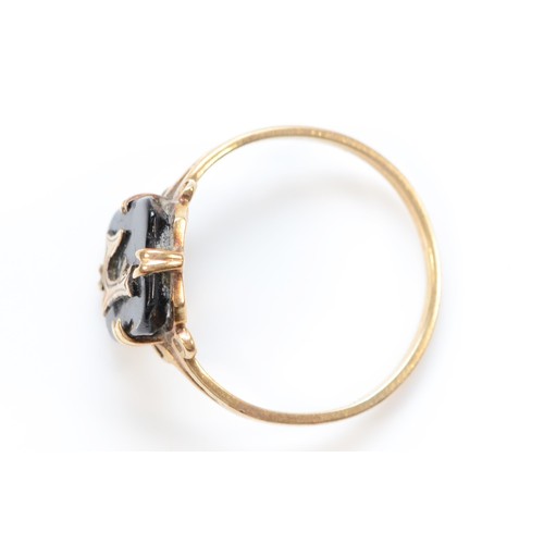 281 - A 9ct gold and onyx initial F ring, K, 1.2g