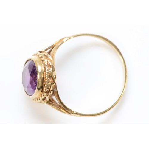 305 - A 9ct gold oval cut amethyst dress ring, O, 3.1g