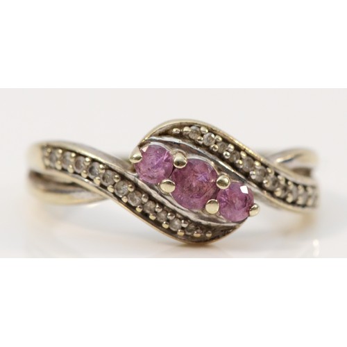 315 - A 9ct white gold pink sapphire and diamond cross over ring, K 1/2, 2.4g