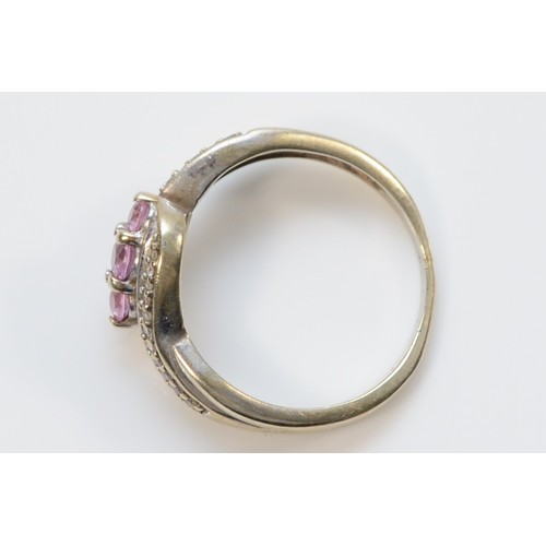 315 - A 9ct white gold pink sapphire and diamond cross over ring, K 1/2, 2.4g