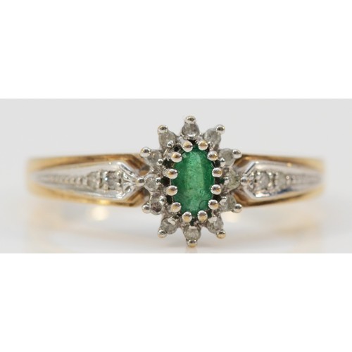 576 - A 9ct gold emerald and diamond cluster ring, with diamond set shoulders, Q 1/2, 2.8g