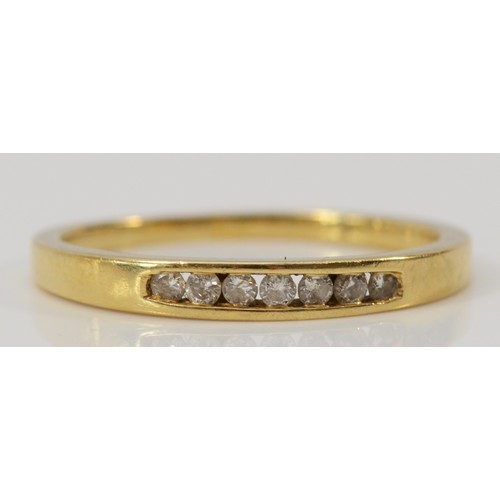 578 - A 9ct gold channel set seven stone brilliant cut diamond ring, O 1/2, 1.9g