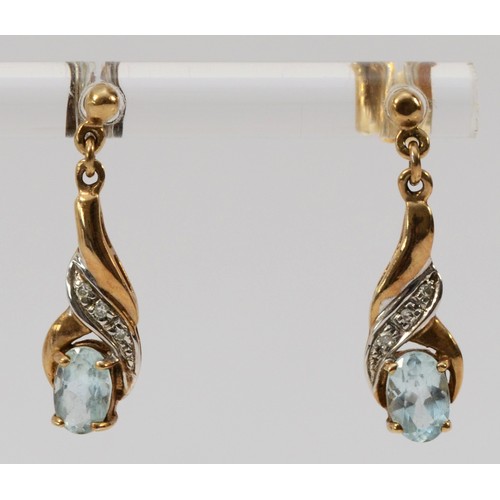 579 - A pair of 9ct gold blue topaz and diamond drop earrings with scroll backs, 23mm drop, 1.7g