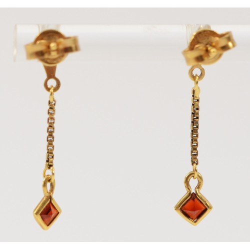 589 - A pair of 9ct gold garnet drop earrings with scroll backs, 25mm drop, 1g