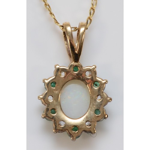 592 - A 9ct gold opal white gemstone and emerald pendant on a chain, 15mm pendant, 2.6g