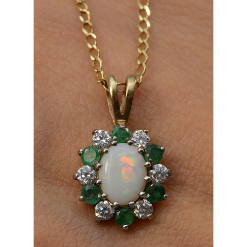 592 - A 9ct gold opal white gemstone and emerald pendant on a chain, 15mm pendant, 2.6g