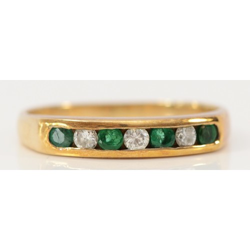 594 - A 9ct gold emerald and brilliant cut diamond channel set half eternity ring, N, 2.4g