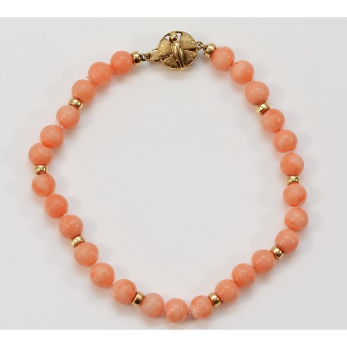 597 - A 9ct gold coral bead bracelet, 21cm, 12.5g